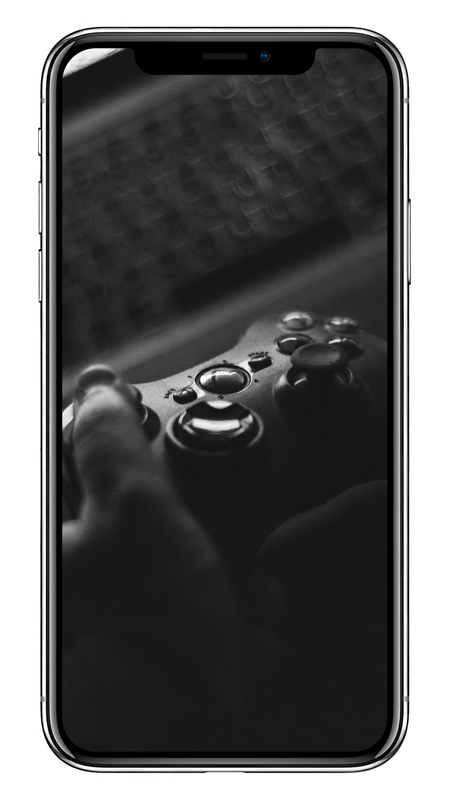 Black and white close-up of hands holding a video game controller.