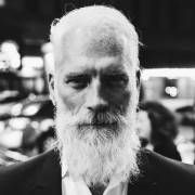 Black and white portrait of an elderly man with a long white beard.